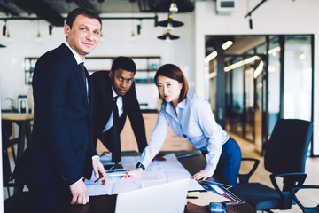 Businesspeople working with project plan in corporate workspace