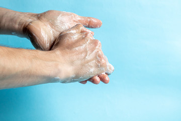 Fototapeta premium A man washes his hands with soap and uses an antiseptic to clean and disinfect his hands. Virus Prevention, Coronovirus. Hygiene concept hand detail.