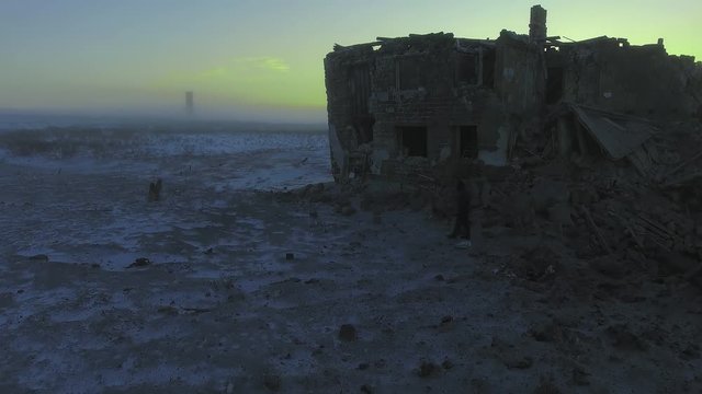 A man walks around the ruins