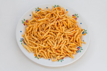 Fresh cooked pasta with light tomato sauce served on a plate