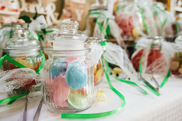 Candy bar with sweets in glasses at wedding