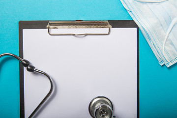 Novel coronavirus 2019-nCoV concept. Medical  protective breathing mask, stethoscope on light blue...