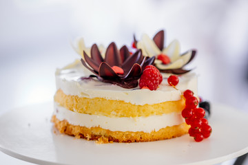 Small wedding naked Cake with cream and berries as dessert