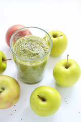 Mixed green smoothie with apples on a white background