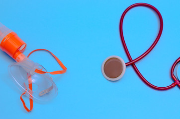 Stethoscope and mask for ventilation of the lungs on a gray background. Device for listening to the...