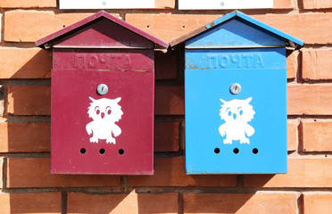 mailboxes on a red brick wall of a house