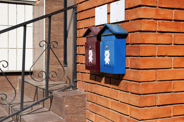 mailboxes on a red brick wall of a house