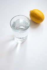 glass of water and lemon isolated on white
