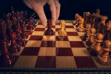  Handcrafted inlaid chess with pieces carved from olive wood. The image has a black background.