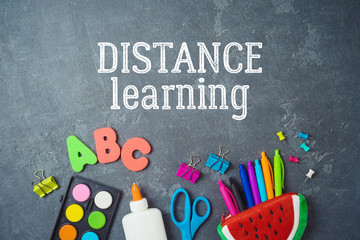 Distance learning and education concept. Study online from home with top view table and school supplies.