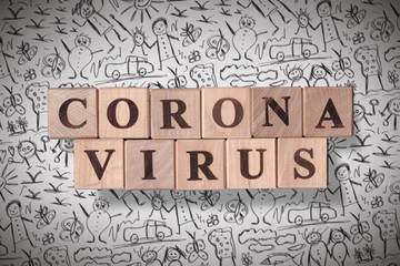 Hand drawn kids scribble background with wooden cubes spelling coronavirus on it. 2019 - 2020 Novel Coronavirus (2019-nCoV) concept art, for an outbreak occurs of covid-19 and its consequences.