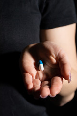 A tablet that treats ailments of a serious infectious disease given on a woman's hand.