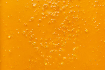 Cream honey or confiture with fruits, texture. Close up, top view.