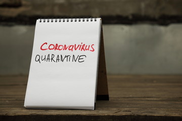 Coronavirus quarantine. Text written by hand on a paper on the table of an empty street cafe