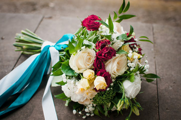 Gold wedding rings on the pink bouquet of flowers