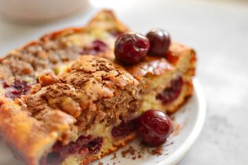 Cupcake with cherries for breakfast. Slice of cake with cherry and cocoa, closeup. Homemade pastries with berries.
