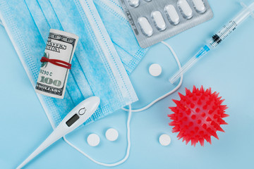 Medical mask, money, pills and thermometer on blue background. Coronavirus concept. 2019 nCoV.