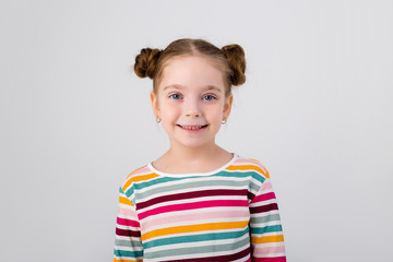 portrait of a sly little girl on a white background