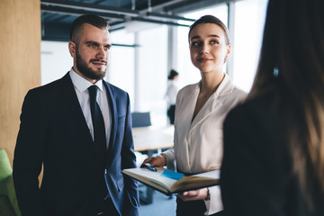 Office workers listening to anonymous colleague