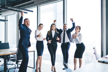 Fototapeta premium Overjoyed business team celebrating success in office
