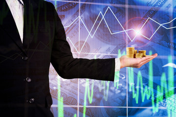Double exposure businessman hold money golden coins in hand on business trading and investment graph