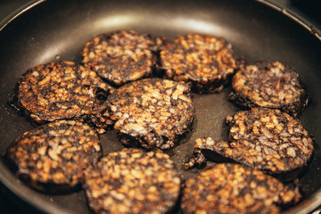 Frying pan frying pork blood sausage during quarantine