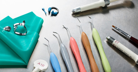 tools and composites for the dentist on metal background