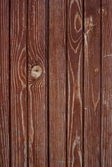 Naklejka premium Shabby old red-brown fence, wooden plank background, rustic, grunge, old fashion