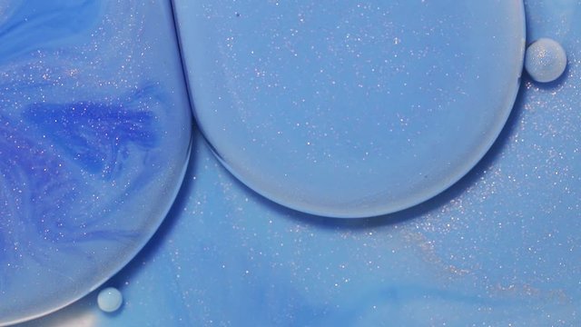 Fluid art drawing video, abstract acryl texture with flowing effect. Liquid paint mixing backdrop with waves and swirl. Detailed background motion with blue and navy blye overflowing colors