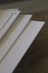 Closeup of sheets of paper on a wooden desk with copy space