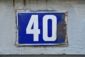A house number plaque, showing the number fourty (40)