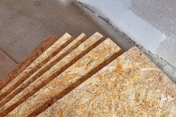 OSB slab building material made from reborn sawdust. They are stacked. Close-up