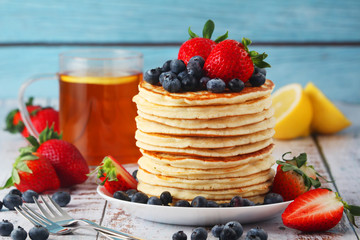 A stack if home-made pancakes with berry	