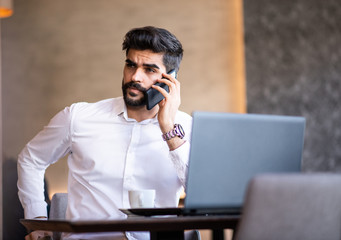 Business person discussing on the phone with an annonymous person.