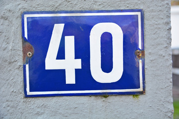 A house number plaque, showing the number fourty (40)