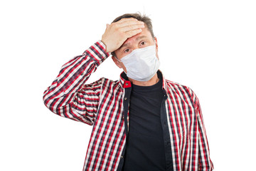 Adult male with a headache in a medical mask