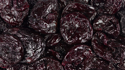 Black bright dried plums close-up