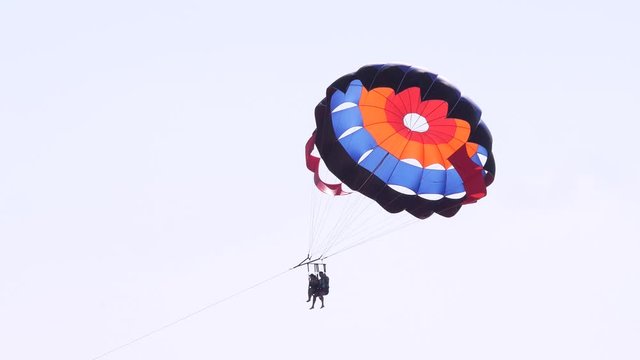 Tourists on a parachute over the sea. Parasailing in the red sea. Holidays concept 4k