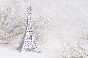 Romantic background with flowers and Eiffel tower miniature
