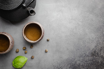 Green japanese tea on black stone table. Top view with copy space
