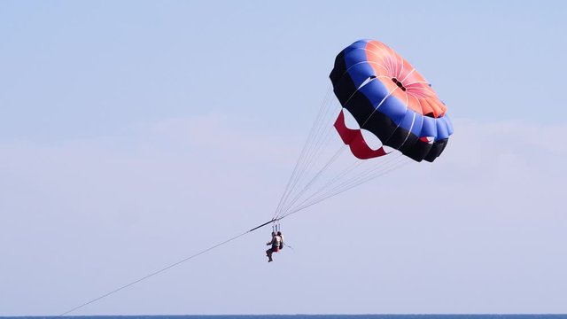 Couple tourists on a parachute over the sea. Parasailing in the red sea. Holidays concept 4k