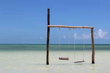 Swings over water on the sea coast, Holbox, Yucatan, Mexico