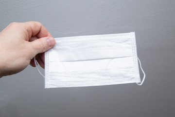 Coronavirus and prevention. Medical mask on a gray background.