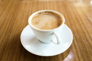 Fototapeta premium Hot latter coffee on wooden cafe table