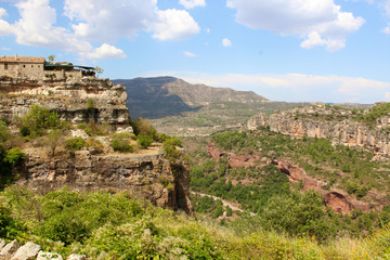 Fototapeta premium Panoramic landscape from a cliff at Siurana - a famous highland village Siurana of the municipality of the Cornudella de Montsant in the comarca of Priorat, Tarragona, Catalonia, Spain.