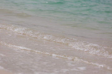 Fototapeta na wymiar Sea beach sand seashore waves small waves