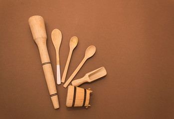 Wooden kitchen tools, spoons on a brown paper background. Concept of eco tools, no plastic. Ziro waste, copy spase