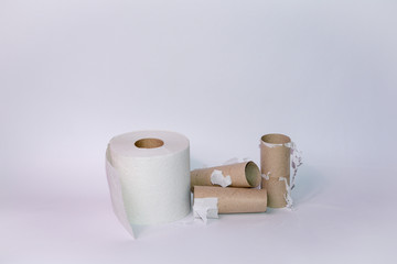 Empty and full toilet paper rolls on white background