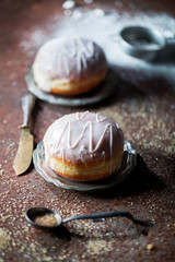 Donuts with icing on a rusty background.