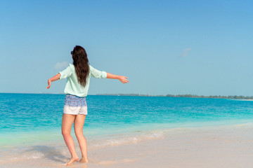 Woman laying on the beach enjoying summer holidays looking at the sea